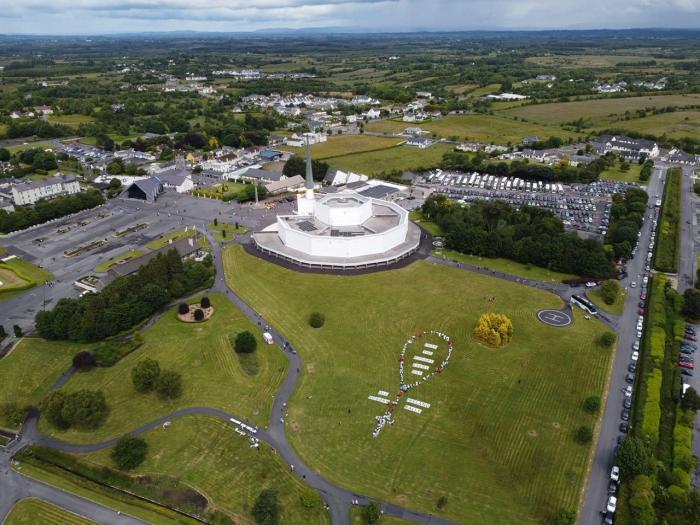 En flygbild av ett "mänskligt radband" bildades på området för den nationella Mariahelgedomen i Knock, Irland, för att markera 40-årsdagen av All Ireland Rosary Rally den 8 juni 2025. Källa: Foto med tillstånd av All Ireland Rosary Rally